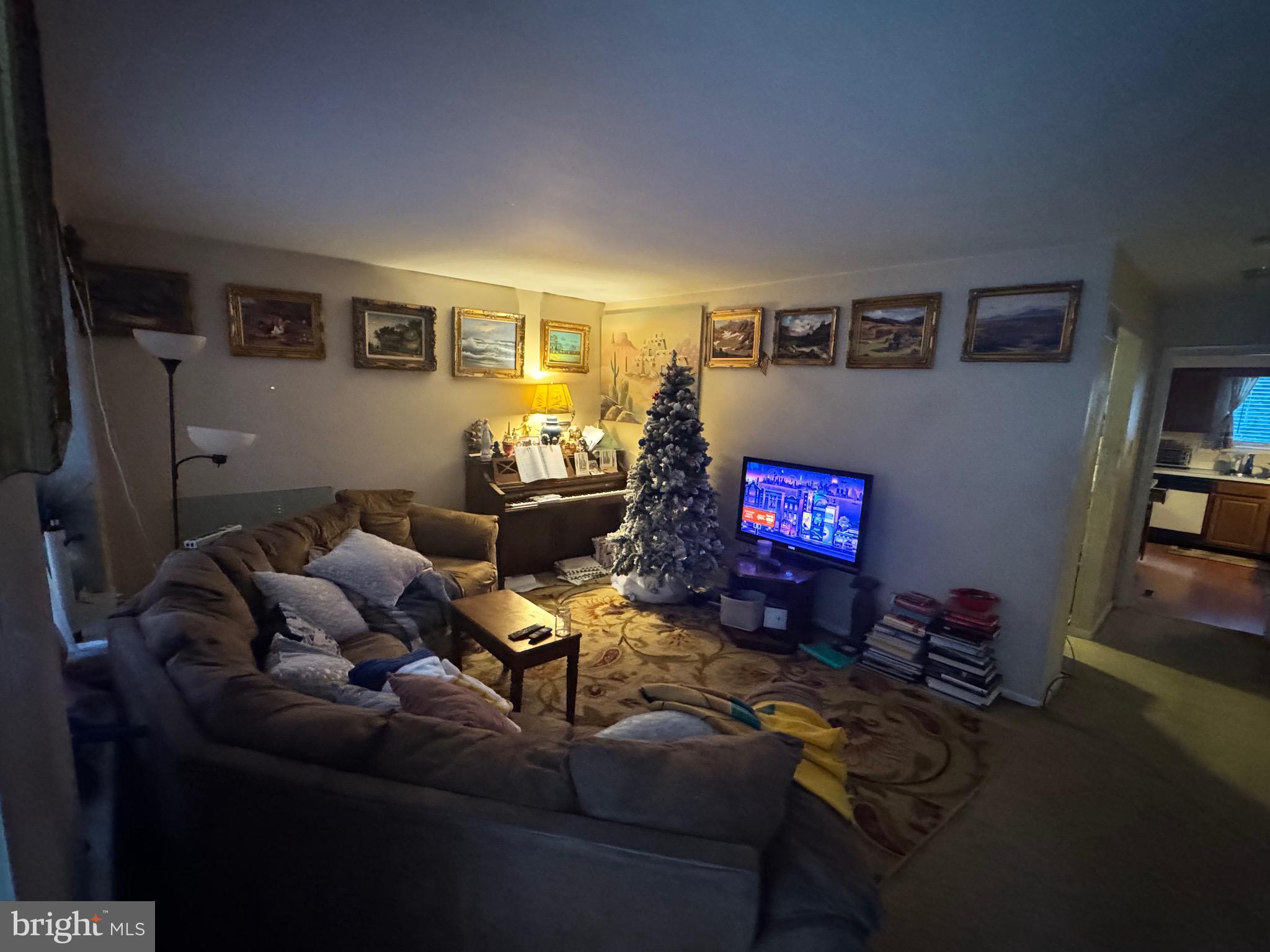 5 Liborio Lane New Castle, DE 19720 - Photo 3 of 18 a living room with furniture and a flat screen tv with rug walls
