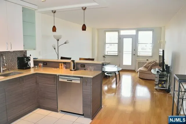 a kitchen with a sink stove and wooden floor
