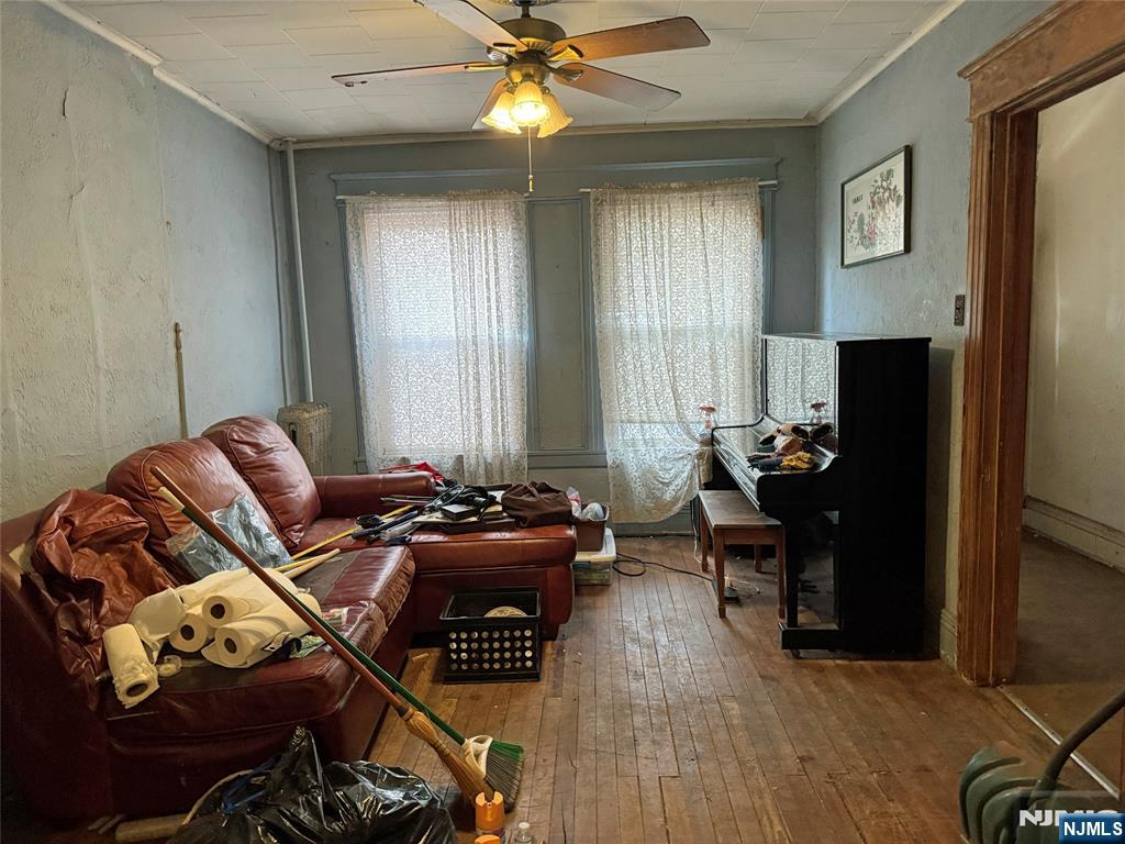 680 1/2 Chestnut Street Kearny, NJ 07032 - Photo 2 of 6 a living room with furniture and wooden floor
