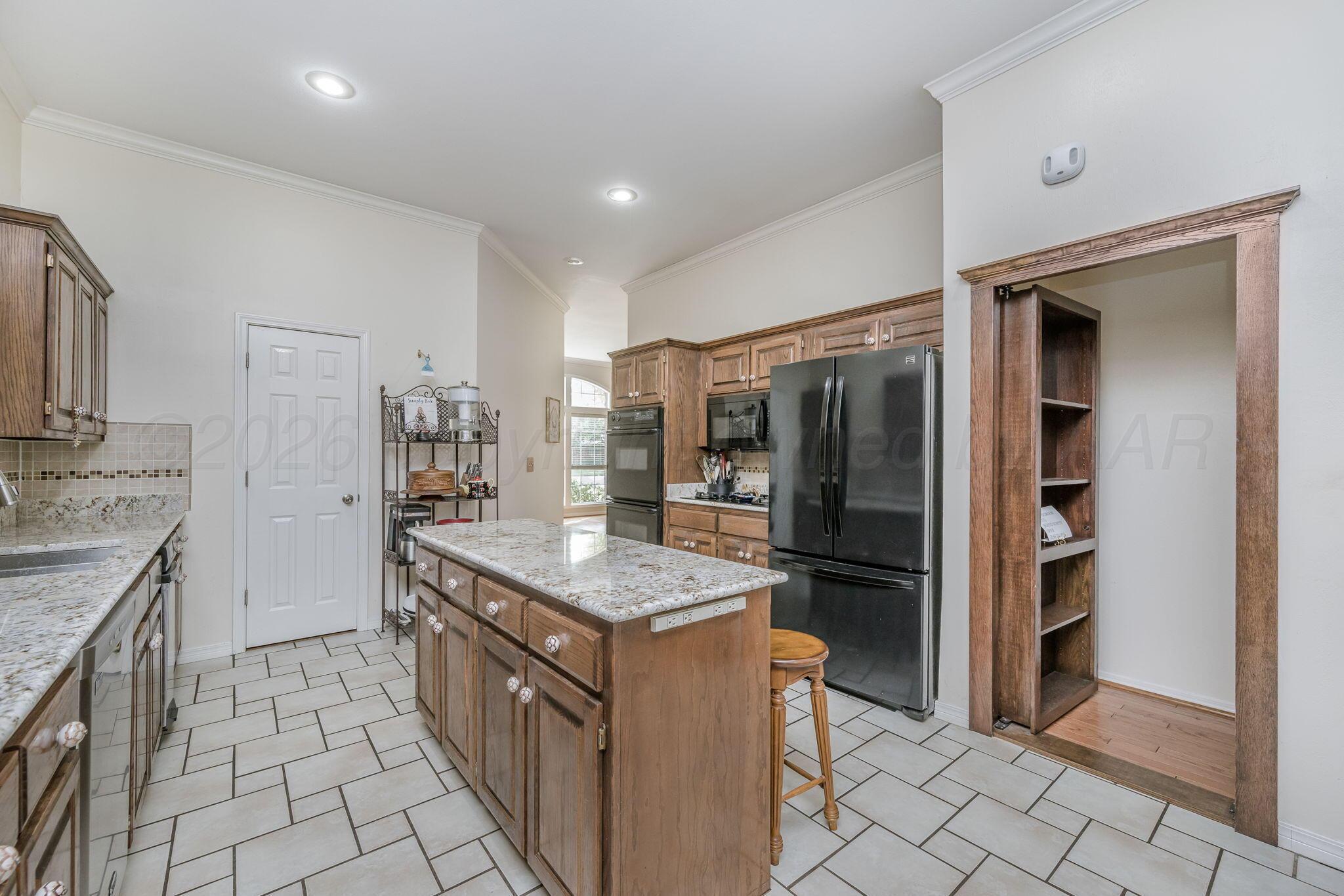 7809 Bent Tree Drive Amarillo, TX 79121 - Photo 8 of 31 a kitchen with stainless steel appliances granite countertop a refrigerator and a stove