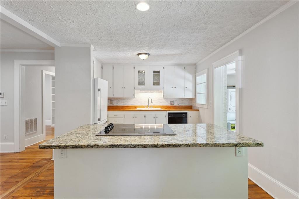 385 Sunset Drive Athens, GA 30606 - Photo 16 of 48 a kitchen with stainless steel appliances granite countertop a sink and a granite counter tops
