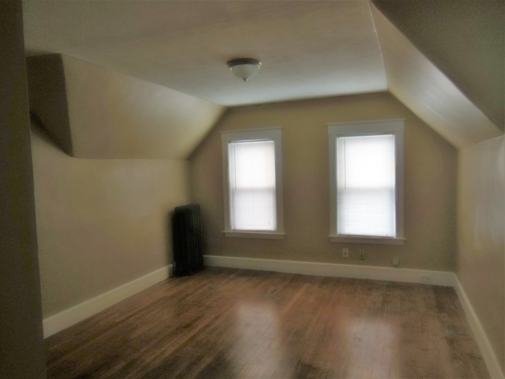 29 Chatham Road Everett, MA 02149 - Photo 12 of 14 a view of an empty room with wooden floor and a window