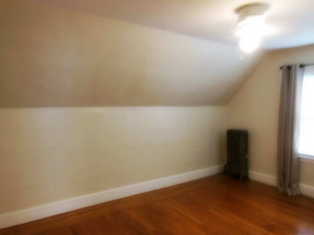 29 Chatham Road Everett, MA 02149 - Photo 13 of 14 an empty room with wooden floor and windows