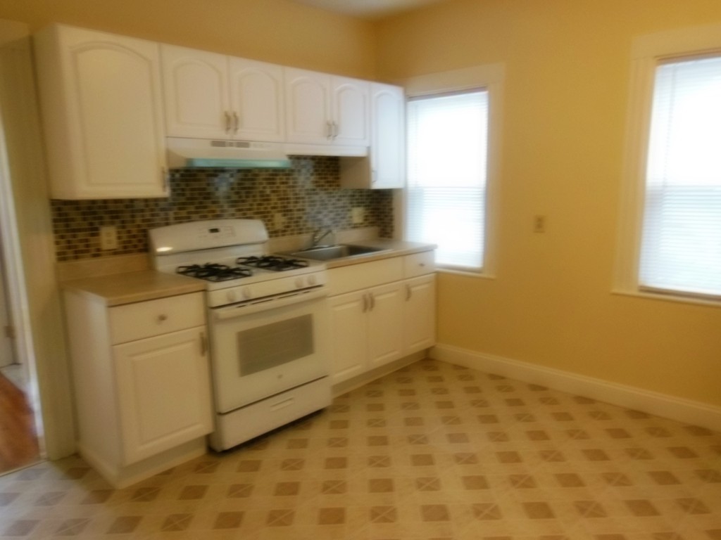29 Chatham Road Everett, MA 02149 - Photo 4 of 14 a kitchen with a stove a sink and a window
