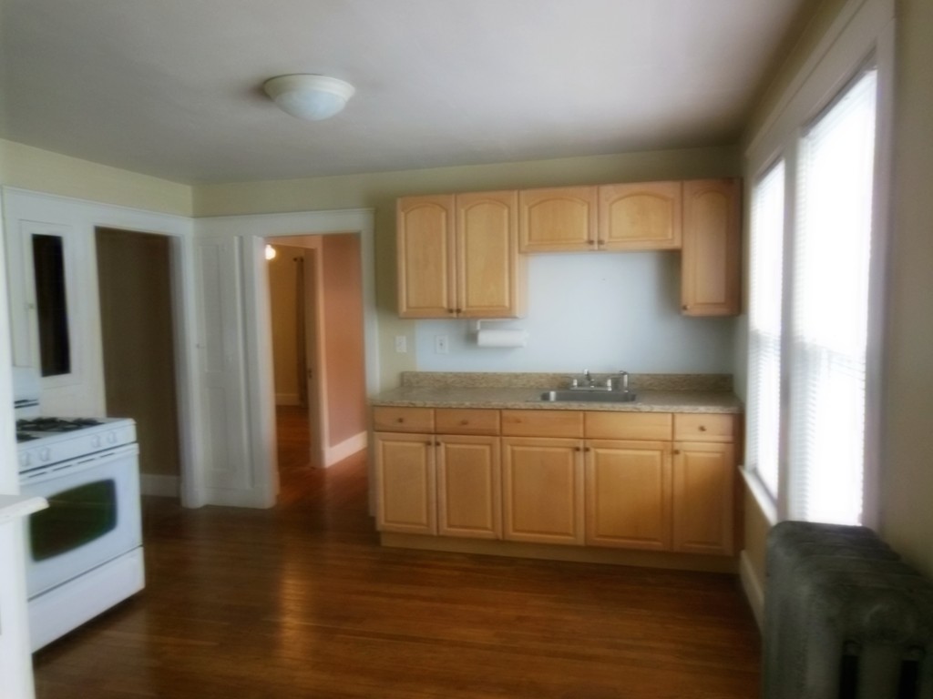 29 Chatham Road Everett, MA 02149 - Photo 6 of 14 a kitchen with granite countertop a refrigerator and a stove top oven
