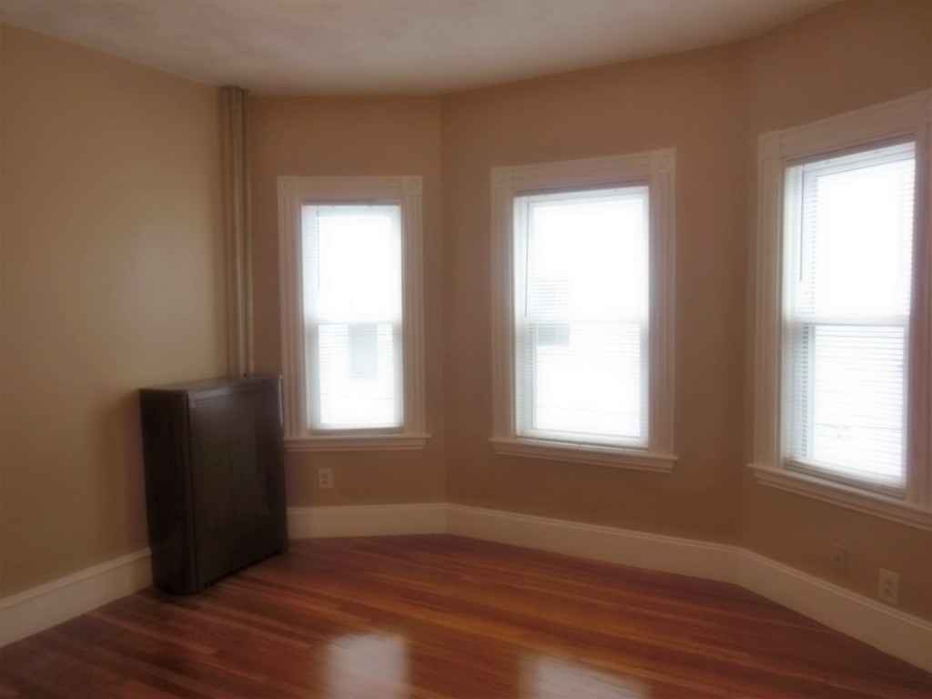 29 Chatham Road Everett, MA 02149 - Photo 7 of 14 a view of an empty room with wooden floor and a window