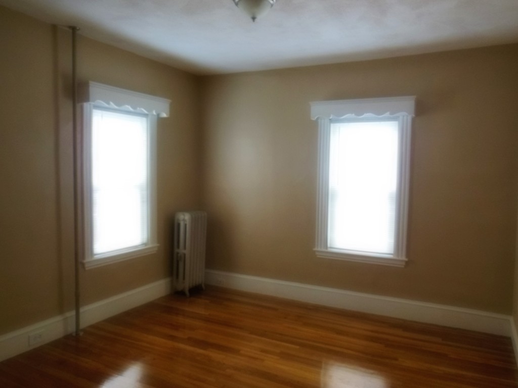 29 Chatham Road Everett, MA 02149 - Photo 9 of 14 an empty room with wooden floor and windows