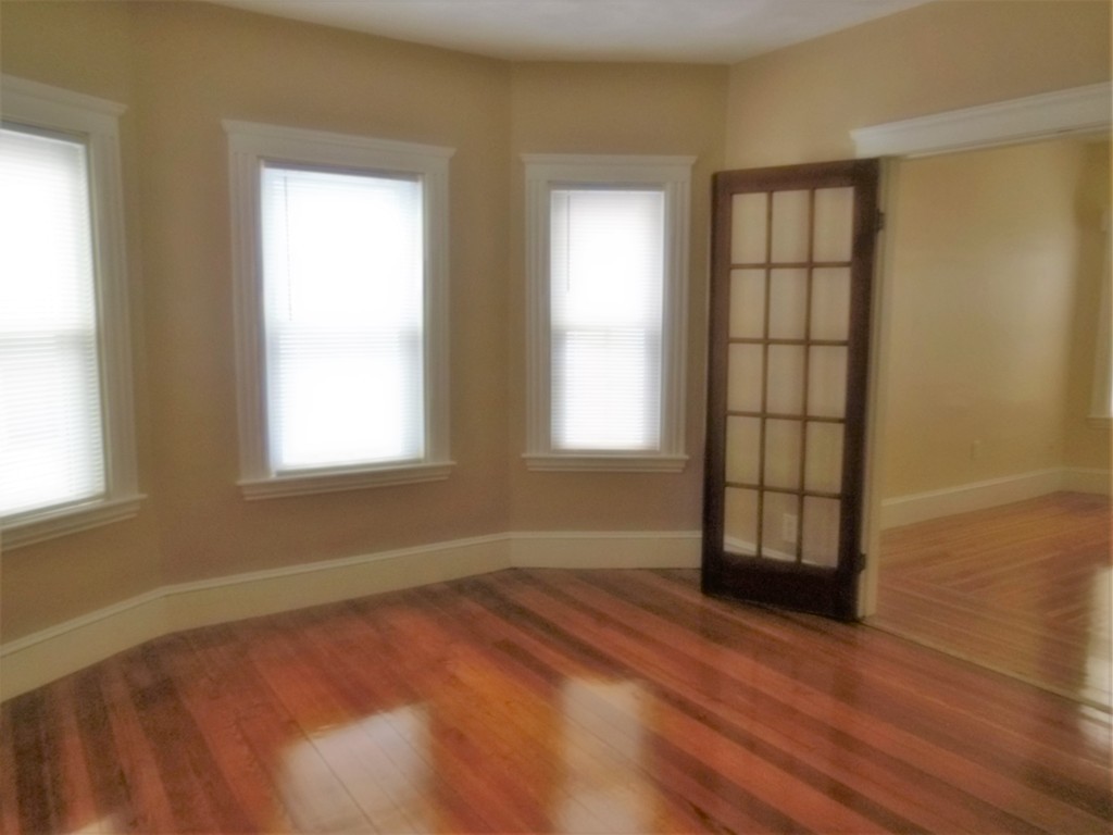 29 Chatham Road Everett, MA 02149 - Photo 10 of 14 an empty room with wooden floor and windows