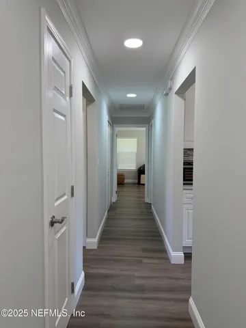 a view of a room with wooden floor and furniture