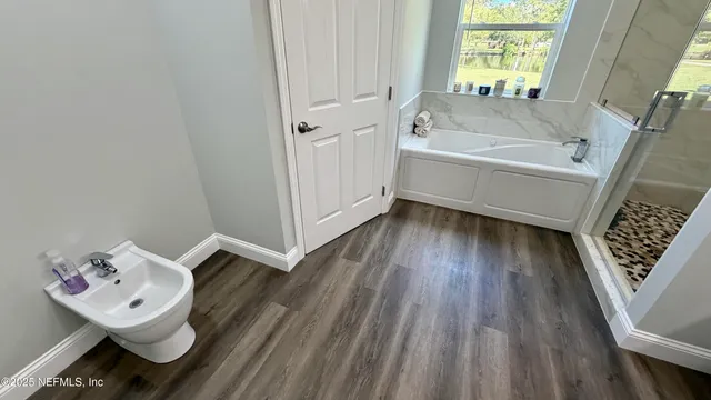 a view of a house with a big yard and a large tree