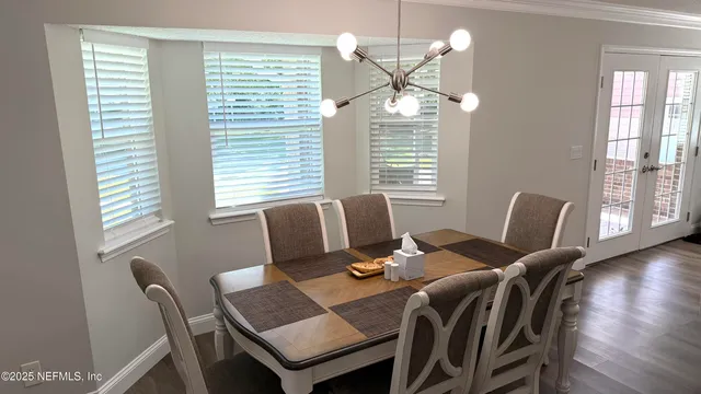 a view of a swimming pool with a lawn chairs under an umbrella