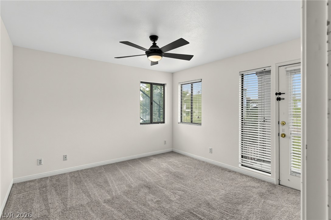 1575 West Warm Springs Road, Unit 2212 Henderson, NV 89014 - Photo 10 of 29 Plush carpeting and natural light define this versatile bedroom space with outdoor access.