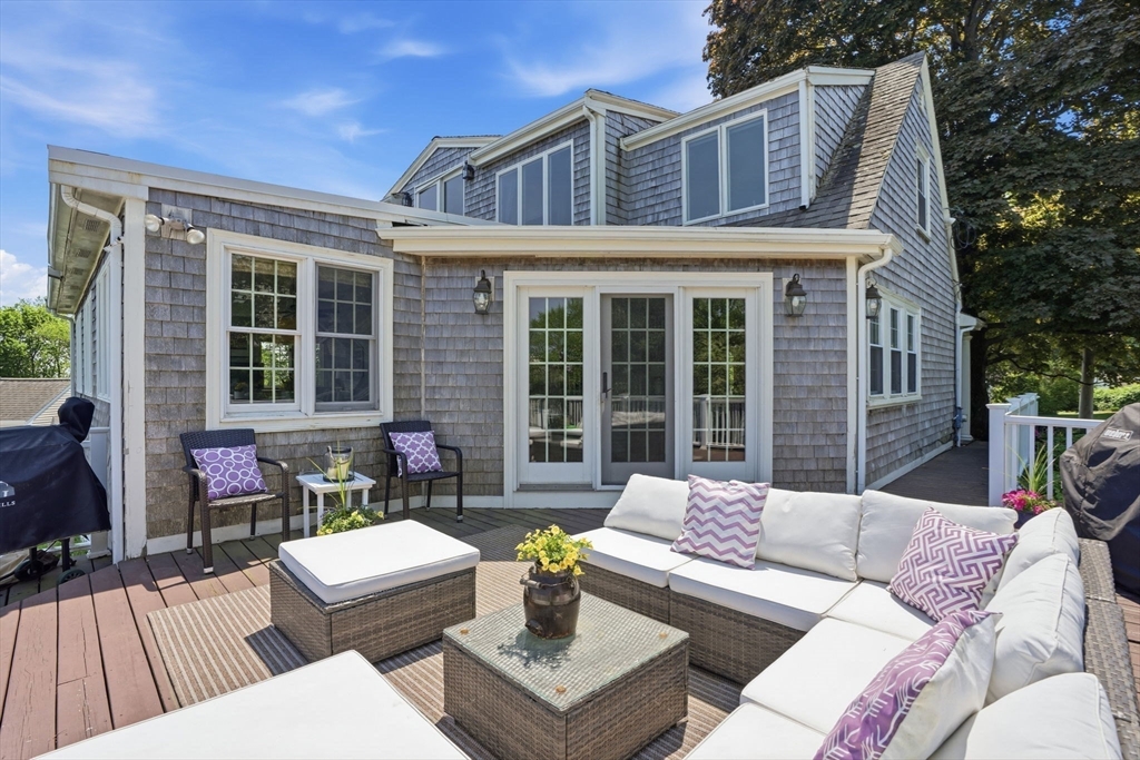 3 Talbot Road Hingham, MA 02043 - Photo 31 of 34 a view of a patio with couches table and chairs with wooden floor and fence