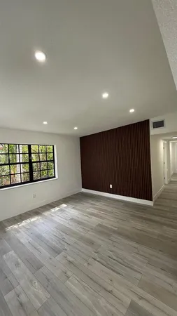 a view of an empty room and a window