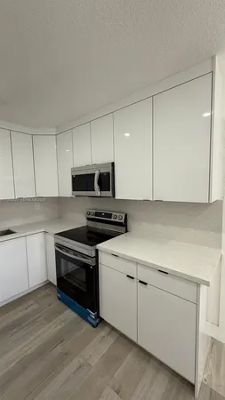 a view of a kitchen with a sink cabinets and a window