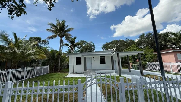 a view of house with roof deck and furniture