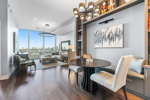 a view of a dining room with furniture and wooden floor