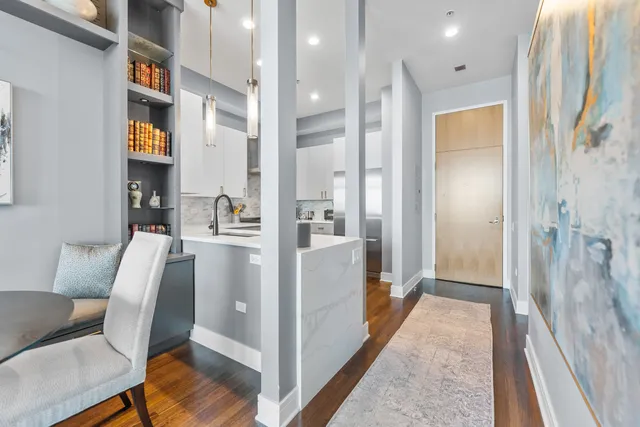 a view of hallway with furniture and wooden floor