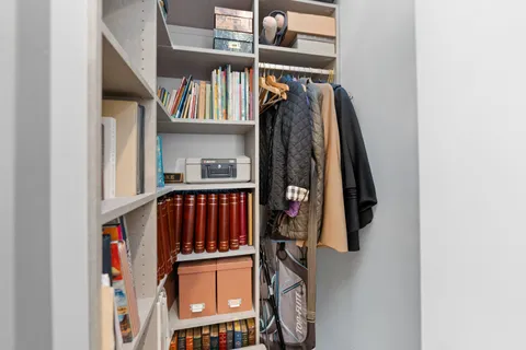a view of walk in closet with clothes and shoes