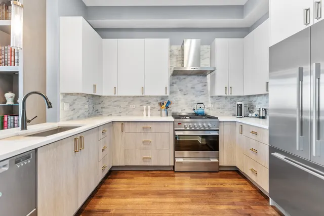 a kitchen with cabinets appliances and a sink