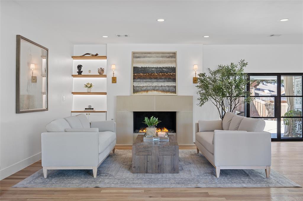 4708 Forest Bend Road Dallas, TX 75244 - Photo 1 of 1 a living room with furniture and a fireplace
