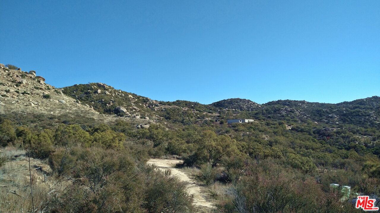 4 Sycamore Falls Road Aguanga, CA 92536 - Photo 48 of 67 a view of a large building with mountains in the background
