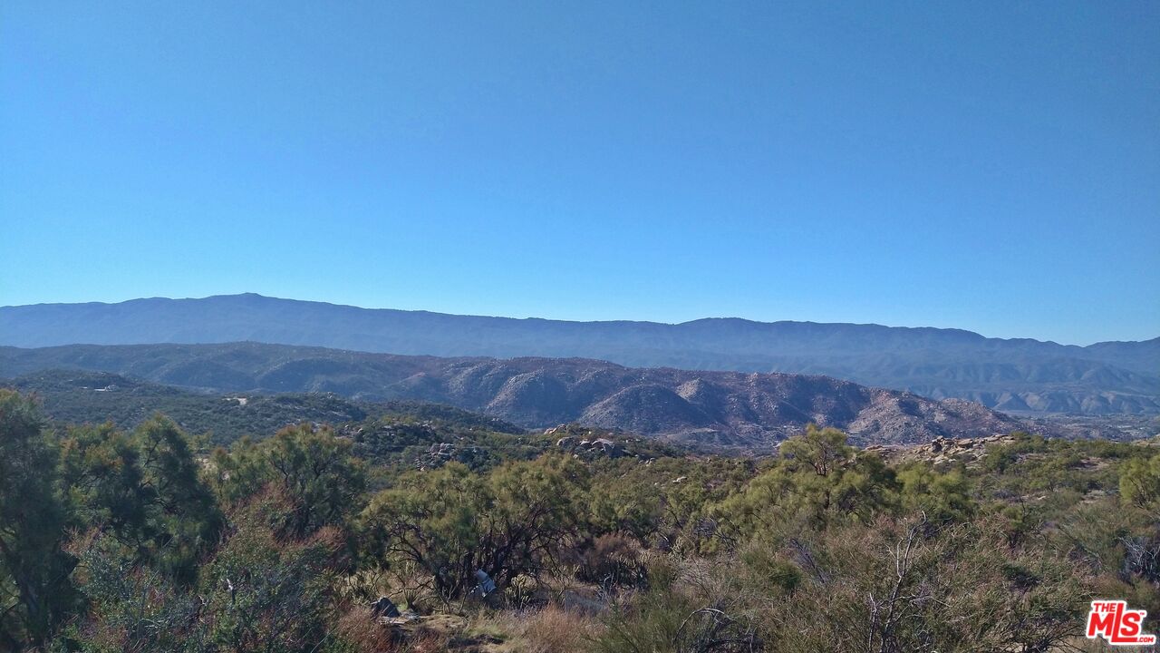 4 Sycamore Falls Road Aguanga, CA 92536 - Photo 51 of 67 a view of a lush green hillside and a houses
