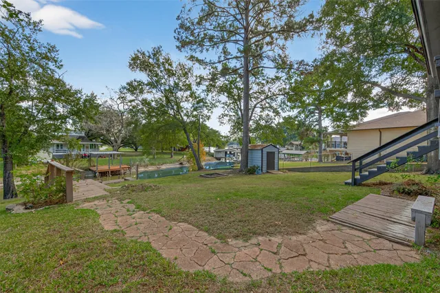 a view of a garden with wooden deck