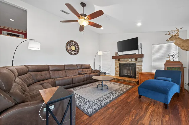 a living room with furniture a rug and a fireplace
