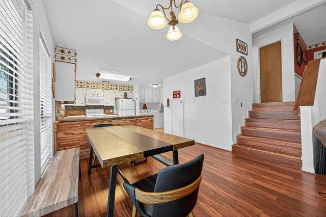 a view of a dining room with furniture and wooden floor