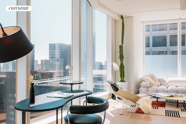 a dining room with furniture and a floor to ceiling window