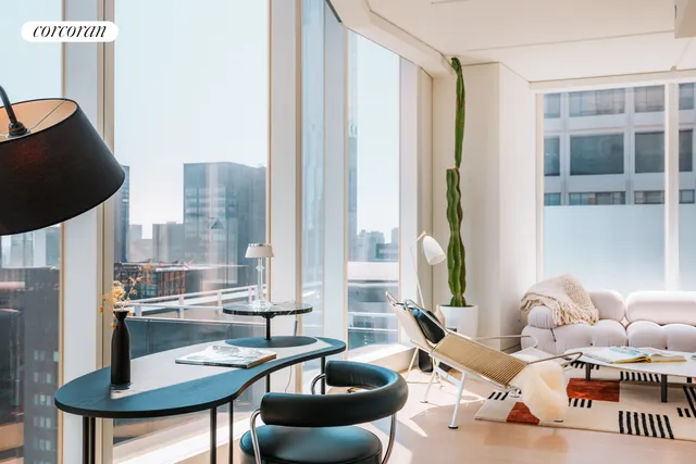 a dining room with furniture and a floor to ceiling window