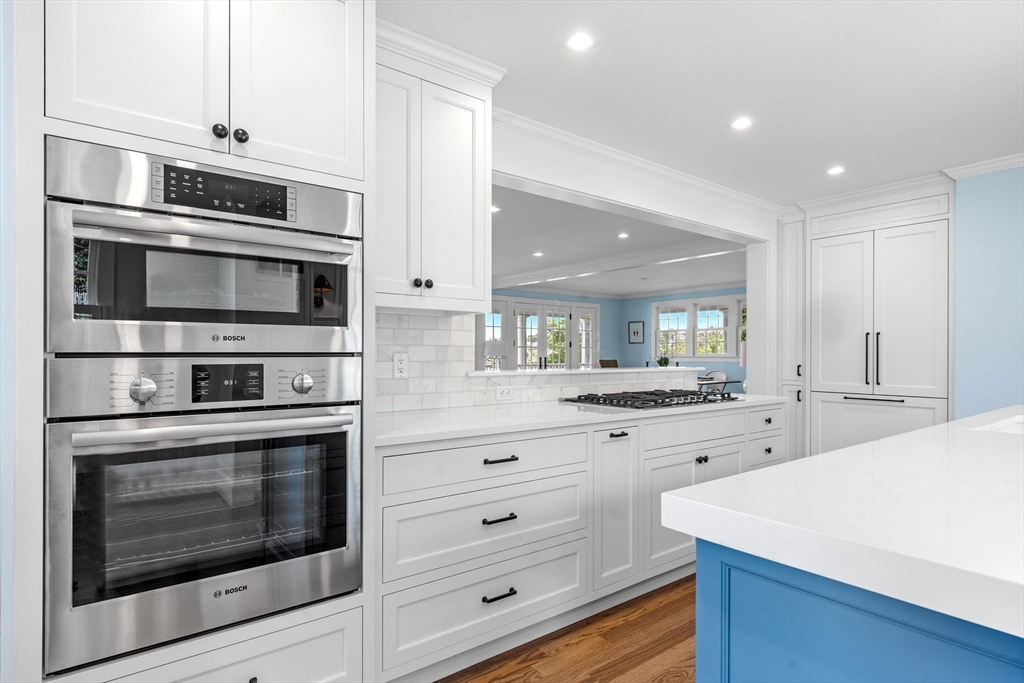 22 Marion Street Hingham, MA 02043 - Photo 13 of 42 a kitchen with stainless steel appliances white cabinets and a stove
