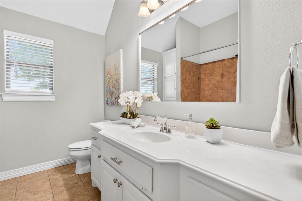 128 Canyon Ridge Trail Aledo, TX 76008 - Photo 33 of 40 The full hallway bath is a stunner. The photo doesn't do justice to the beautiful Sea Salt paint. LOVE the big vanity and the built-in storage!