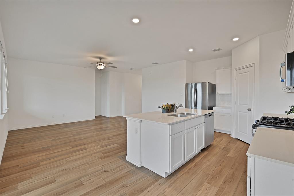 3204 Renaissance Drive Denton, TX 76207 - Photo 11 of 25 Open-concept living space featuring wood-finish flooring, recessed lighting, and a ceiling fan