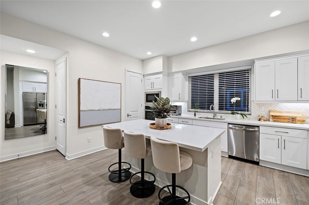 769 Doheny Way Dana Point, CA 92629 - Photo 15 of 35 a kitchen with a dining table chairs refrigerator and cabinets