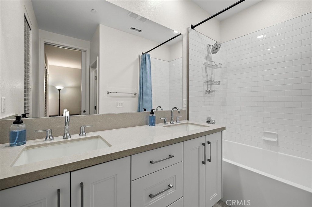 769 Doheny Way Dana Point, CA 92629 - Photo 27 of 35 a bathroom with a sink double vanity granite tub shower and a mirror