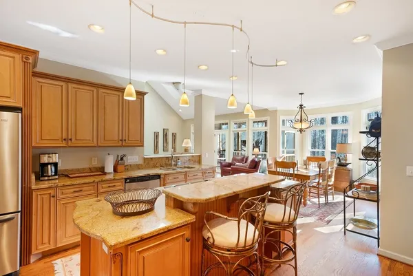 a large kitchen with a table and chairs in it