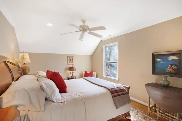 a bedroom with a bed and wooden floor