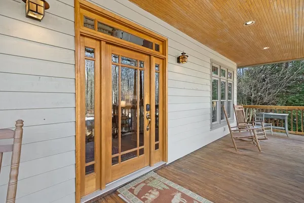 a view of a porch with furniture and floor to ceiling window