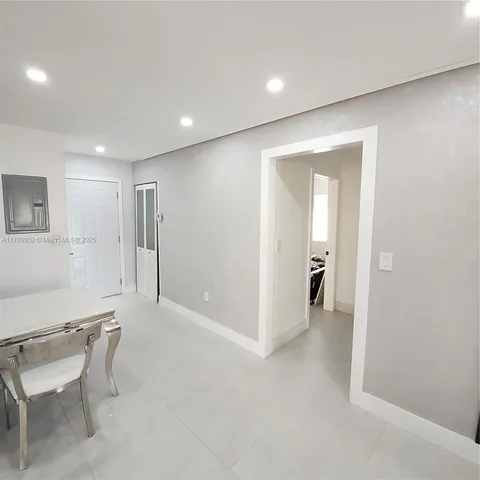 a view of a room with a hallway and a chair