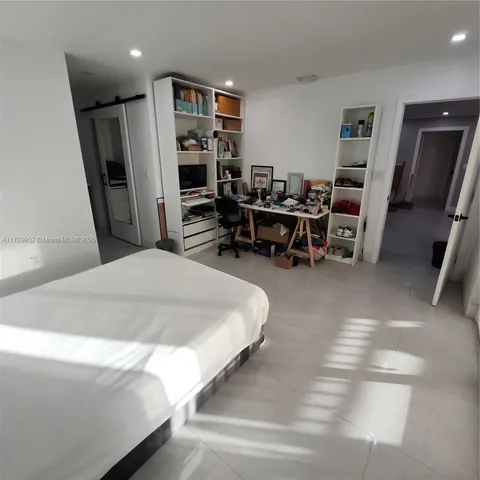 a bedroom with furniture and a book shelf