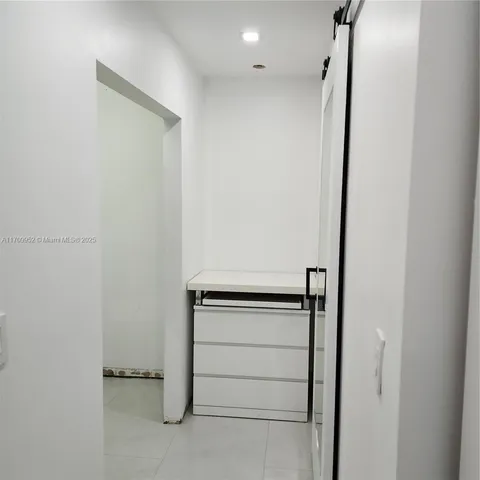 a view of walk in closet with clothes