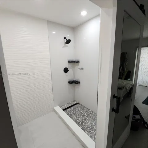 a bathroom with a toilet and a shower