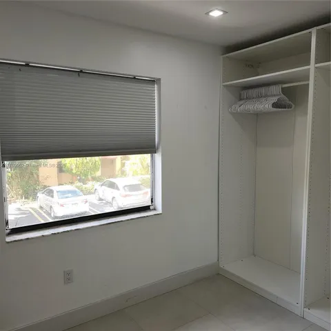 a bathroom with a sink a toilet a mirror and shower