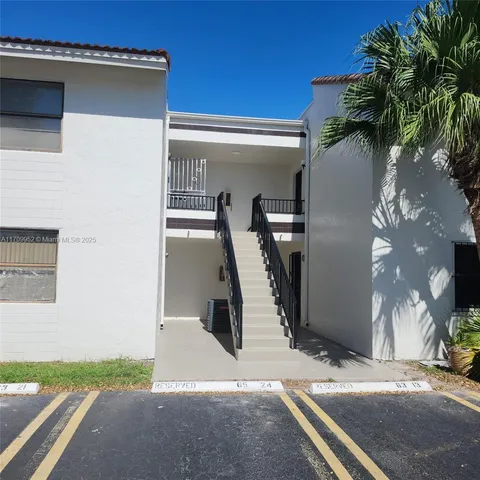 a view of a street with cars and palm trees