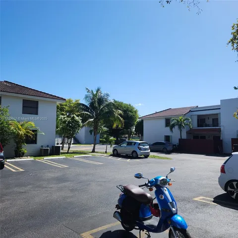 a green field with lots of trees