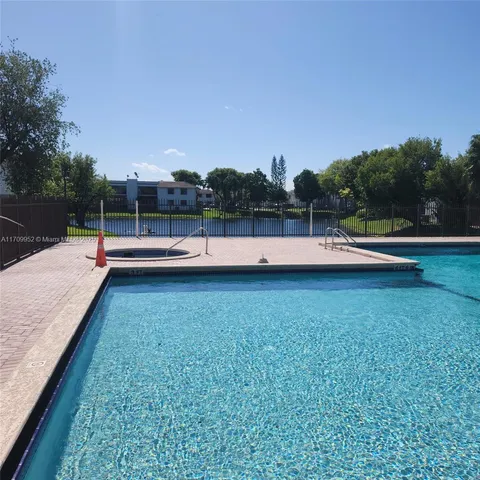 a view of a yard with wooden fence