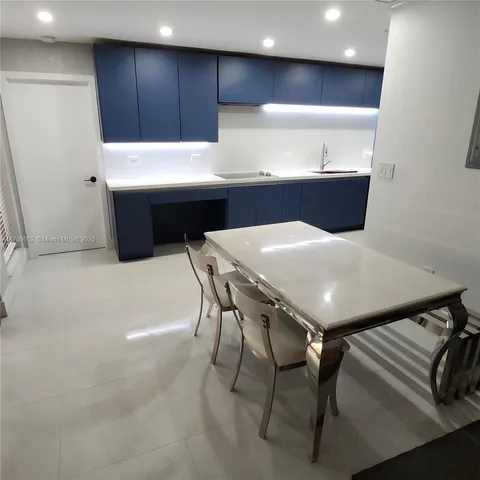 a kitchen with cabinets and wooden floor
