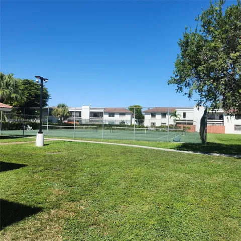 a view of a house with a yard and plants